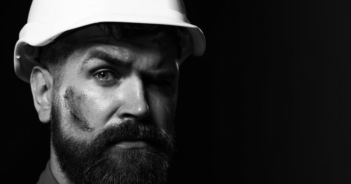 Closeup portrait of construction worker, engineer or architect in helmet. Mechanical or industrial worker in protective hardhat. Male builder in hard hat. Copy space for advertising. Black and white.