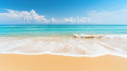 Fototapeta premium The tranquil turquoise waves gently lap against the golden sand, creating a serene atmosphere on a bright, sunny day