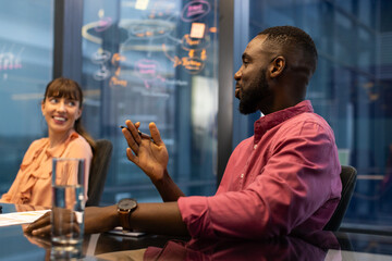 Discussing project ideas, colleagues collaborating in modern office meeting room