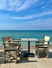Table and chairs by the sea in Greece
