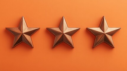 Obraz premium Three bronze stars are displayed in a row on an orange background.