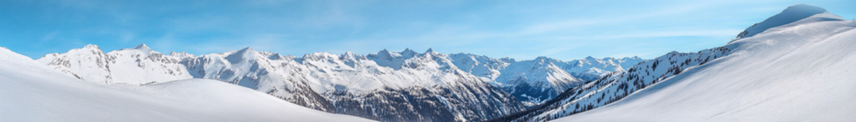 A highly detailed mountain panorama, where each peak and ridge is rendered with precision. The snow-covered landscape contrasts with the deep, shadowy valleys, creating a rich visual tapestry of