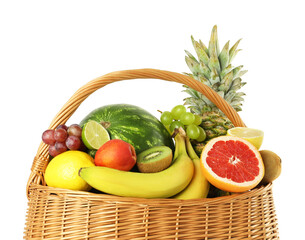 Many fresh ripe fruits in basket isolated on white