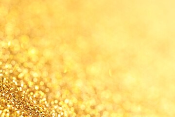 Beautiful shiny golden glitter as background, closeup