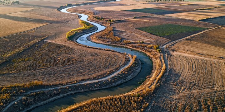 A drone's-eye view of a network of irrigation ditches channeling water to multiple crop fields in a semi-arid region