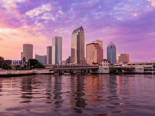 Platt Street Bridge crossing the Hillsborough River and buildings in downtown Tampa during a dramatic sunset, Florida, United States.