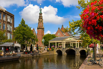 Naklejka premium Cityscape of Leiden, South Holland, Netherlands. Embankment of city canal, view of bridge, town hall and Heilige Lodewijkkerk (St. Louis Church).