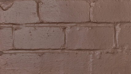 Close-up horizontal photo of a heavily painted brown brick wall with copy space.