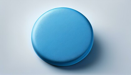 A flat, circular blue pill with subtle texture, centered on a plain white background, leavin