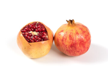 open pomegranates, and pomegranate seeds isolated on white background.
