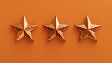 Obraz premium Three gold stars are arranged in a row on a solid orange background. They are evenly spaced, with the points of the stars facing the viewer. The background is out of focus.