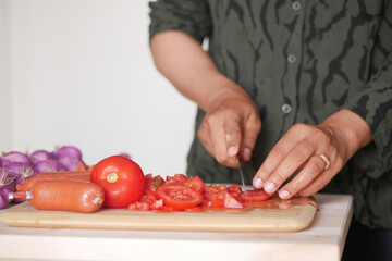 An Exciting Culinary Moment Slicing Fresh and Colorful Vegetables in the Kitchen for Cooking