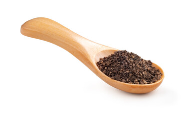 Coarse black pepper in a wooden spoon on a white background. A f