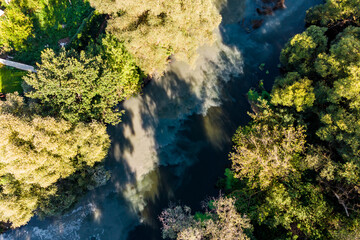 Aerial view of polluted riverbed, sewage discharge into river