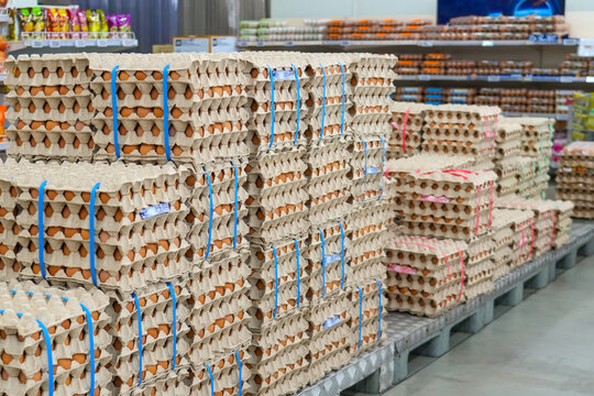 Many stacks of rows and paper packaging for chicken eggs, stacked in a store, brought from poultry farms in rural areas for sale in city stores