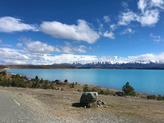 Pristine Lake with Snow-Capped Mountains and Blue Skies