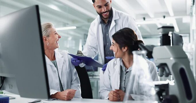 Clipboard, computer and success with science people in lab for breakthrough, report or research. Desk, innovation and laughing with doctors working together for pharmaceutical discovery or solution
