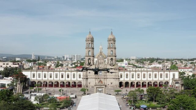 Aerial images following a drone as a protagonist through the main square of Zapopan Mexico, The drone travels around the principal church in the city.