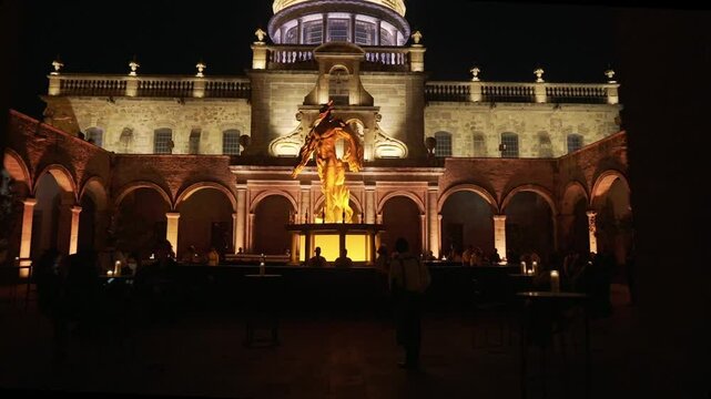 This is the Hospicio Caba&ntilde;as in Guadalajara Mexico at night. It is a historic building that constantly hosts large social events. This sculpture is a representation of the Hombre en llamas mural.