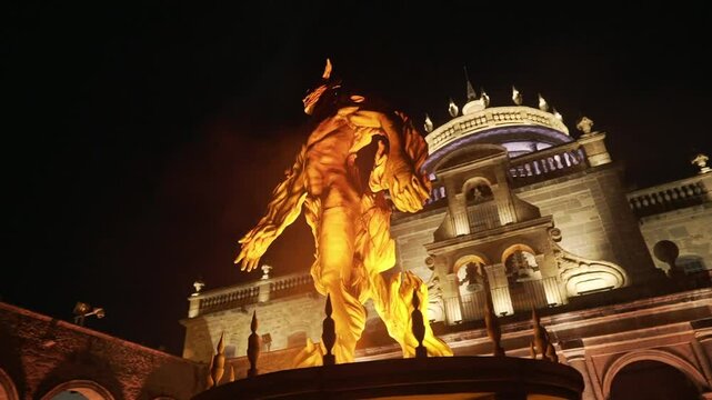 This is the Hospicio Caba&ntilde;as in Guadalajara Mexico at night. It is a historic building that constantly hosts large social events. This sculpture is a representation of the Hombre en llamas mural.