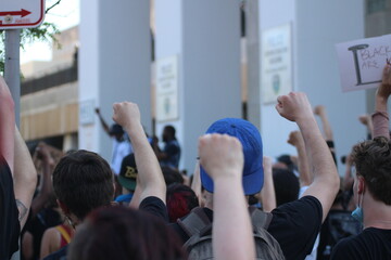 Group of protesters holding their fists in the air