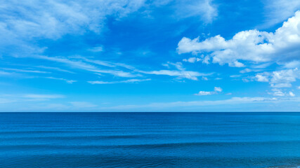 Nature of the beach and sea Summer with sunshine, sandy beaches, clear blue waters sparkling against the blue sky. On an island with good ecology and environment Background for summer vacation concept