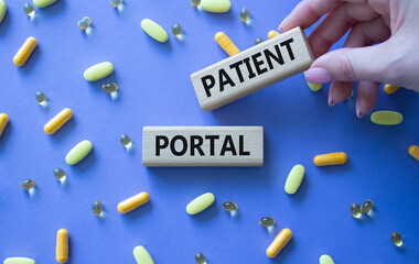 Patient Portal symbol. Concept word Patient Portal on wooden blocks. Beautiful purple background...