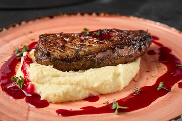 Exquisite Duck Breast Fillet on Creamy Mashed Potatoes with Berry Sauce in Artistic Gourmet Presentation