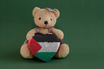 teddy bear on green background with the flag of Palestine. Unitary state