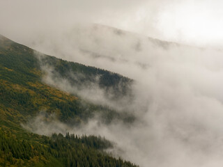 Early autumn scenery in the Transylvanian Alps with mist and storm clouds