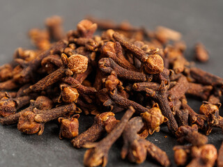 A close-up of aromatic cloves, highlighting the texture and rich color
