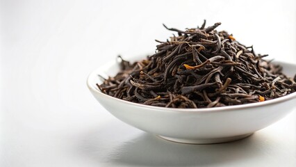 Fototapeta premium Extreme close-up of black tea leaves in a white dish on a white background