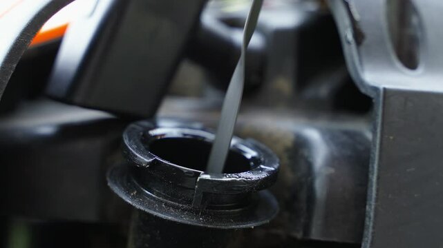 Close-up, oil dipstick with clean oil and acceptable level