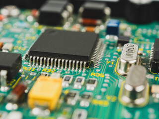 Close-up of microcircuits and components: chips, diodes and capacitors on a printed circuit board,...