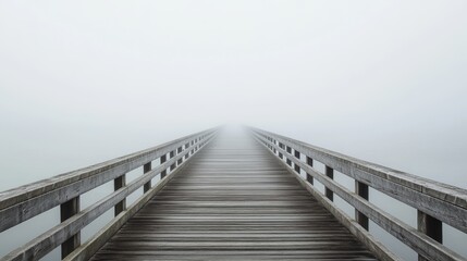 Naklejka premium Foggy Wooden Bridge Leading into the Mist - Serene Landscape Photography