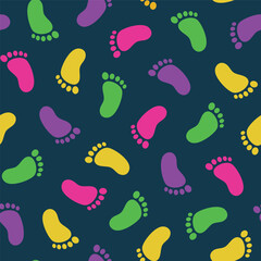 seamless pattern of repeating colorful footprints on a dark background