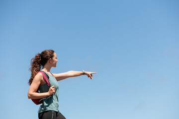 Young woman enjoying nature.Hiking in the mountains, observing the landscape.Doing sports and physical activity.Let's take care of our natural surroundings and our environment.Moments of disconnection