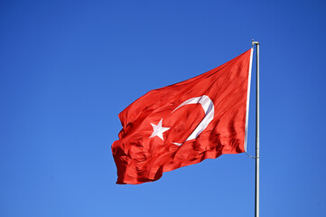 Turkish Flag with crescent and stars waving in the wind