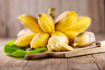 Bunch of bananas with banana leaves and sliced pieces. Perfect for healthy food, tropical concepts, and natural ingredients