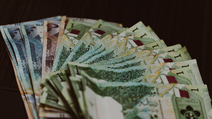 Currencies and money exchange trading concepts. Qatari 500 Riyals Bank Note . Qatari Currency roll