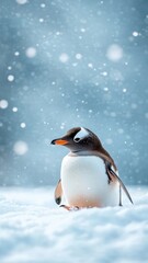 Obraz premium Charming penguin sliding across a snowy landscape, with snowflakes falling on its feathers and the wintery setting adding to the playful atmosphere.