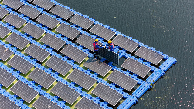 Floating solar panels providing renewable energy. Aerial view floating on solar cells
