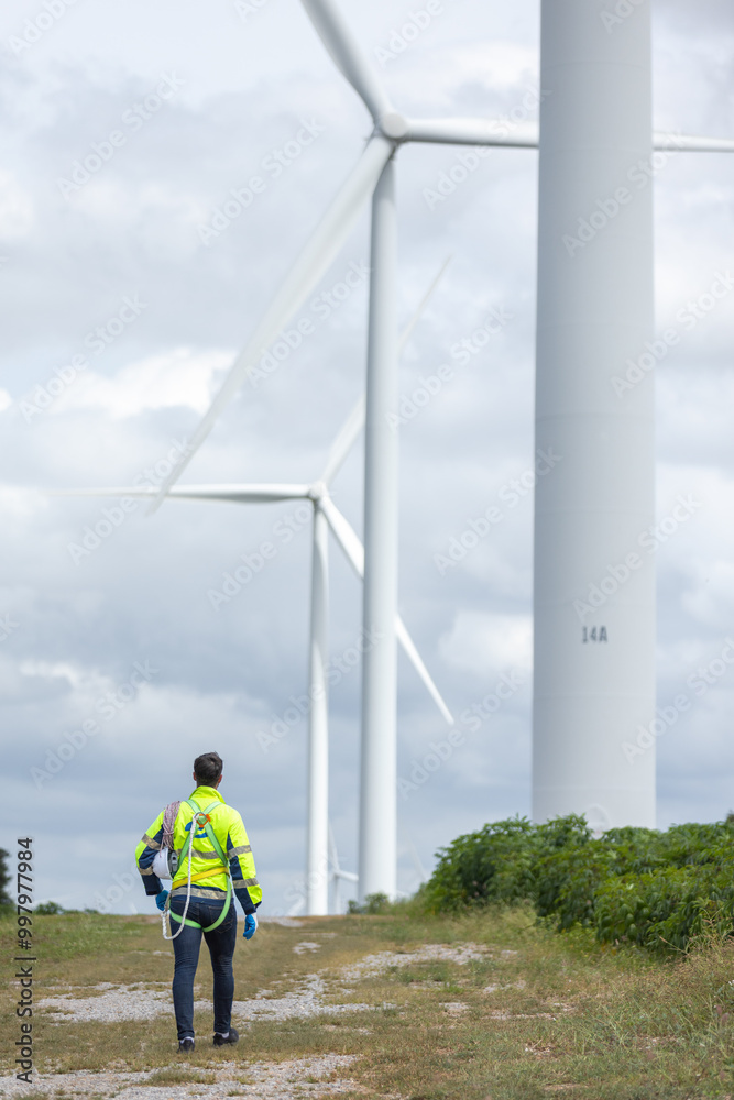 Poster Man engineers holding tools box and rope to maintenance working in wind turbine. Renewable energy power wind turbine. Technology protect environment reduce global warming problems