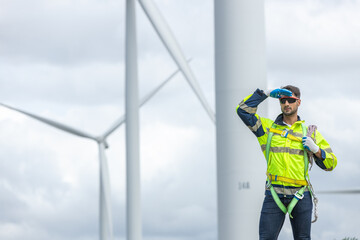 Man engineers holding tools box and rope to maintenance working in wind turbine. Renewable energy power wind turbine. Technology protect environment reduce global warming problems