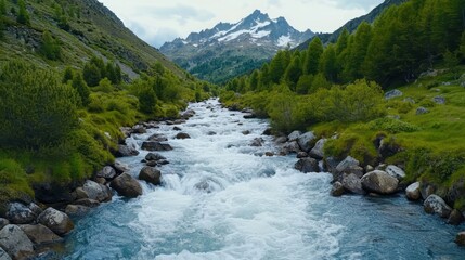 A serene mountain river flows through lush greenery with majestic peaks in the background, creating a peaceful landscape.