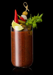 Hot pepper bloody mary mix cocktail with olive,celery on black background with lime slice