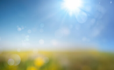 Fototapeta premium Fresh spring blue sunny sky background with a blurred, warm and sunny glow.