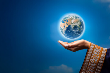 Woman hand holding planet earth on clear cloudy sky background, copy space. Woman with traditional...