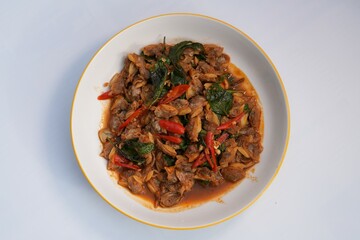 One of the foods that Thai people eat is stir-fried cockles with holy basil.