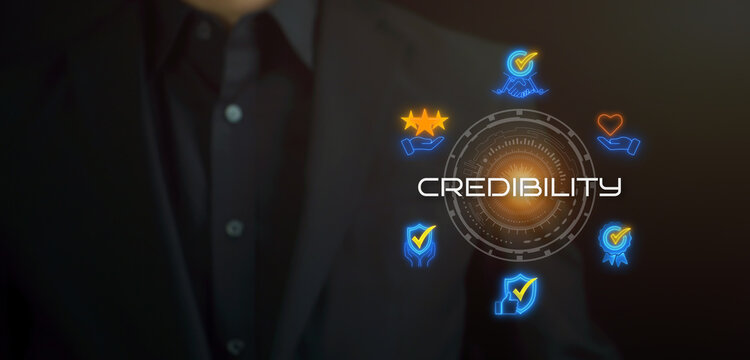 Businessman showing glowing neon line banner of credibility concept with icons of integrity, trust, reliable, authentic, commitment and reputation on virtual screen.